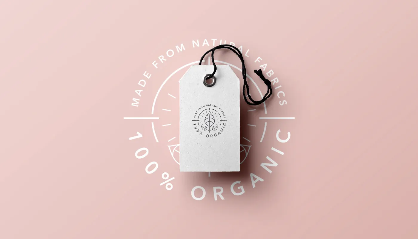 The organic stamp on the clothing tag — the eco story made tangible.